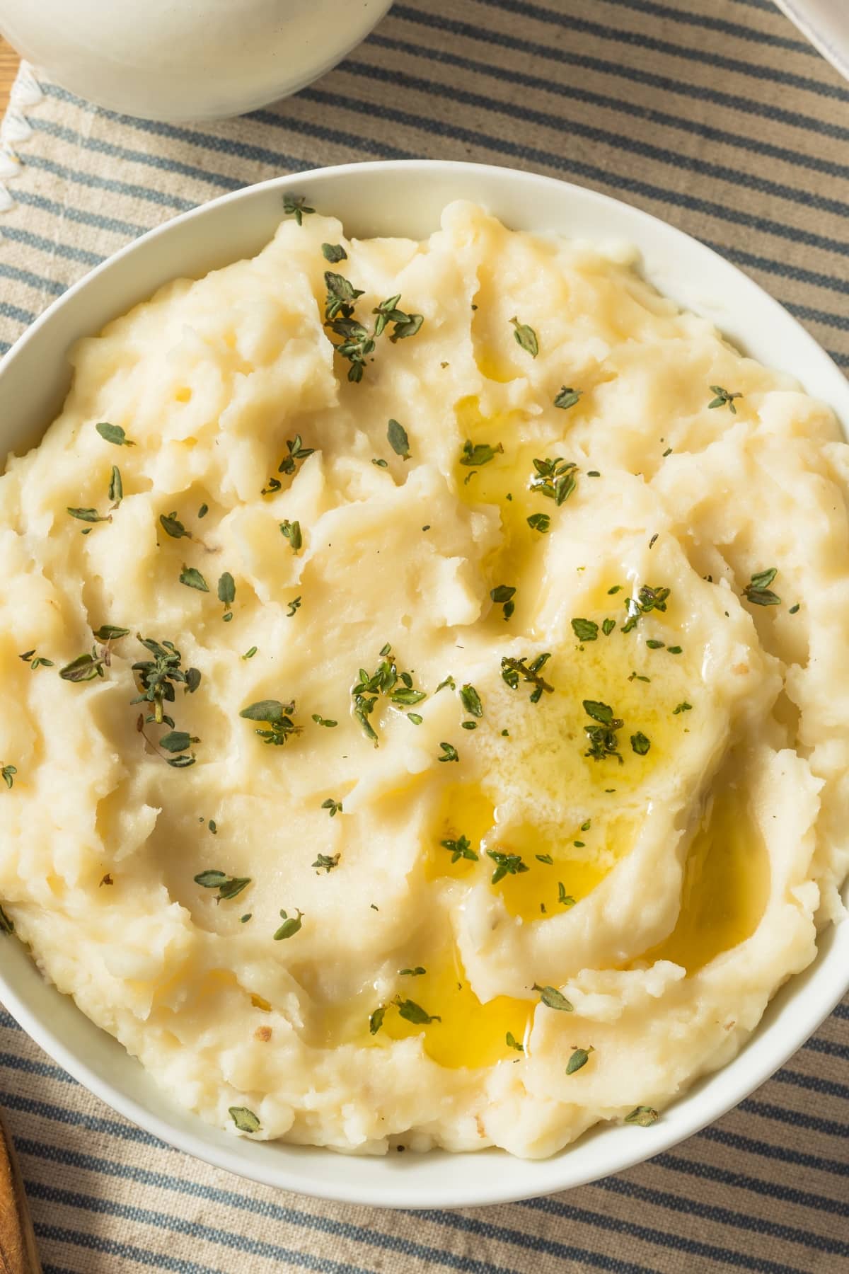 Can You Freeze Mashed Potatoes? (Easy How-To)  featuring Bowl of Homemade Mashed Potatoes with  Melted Butter and Herbs