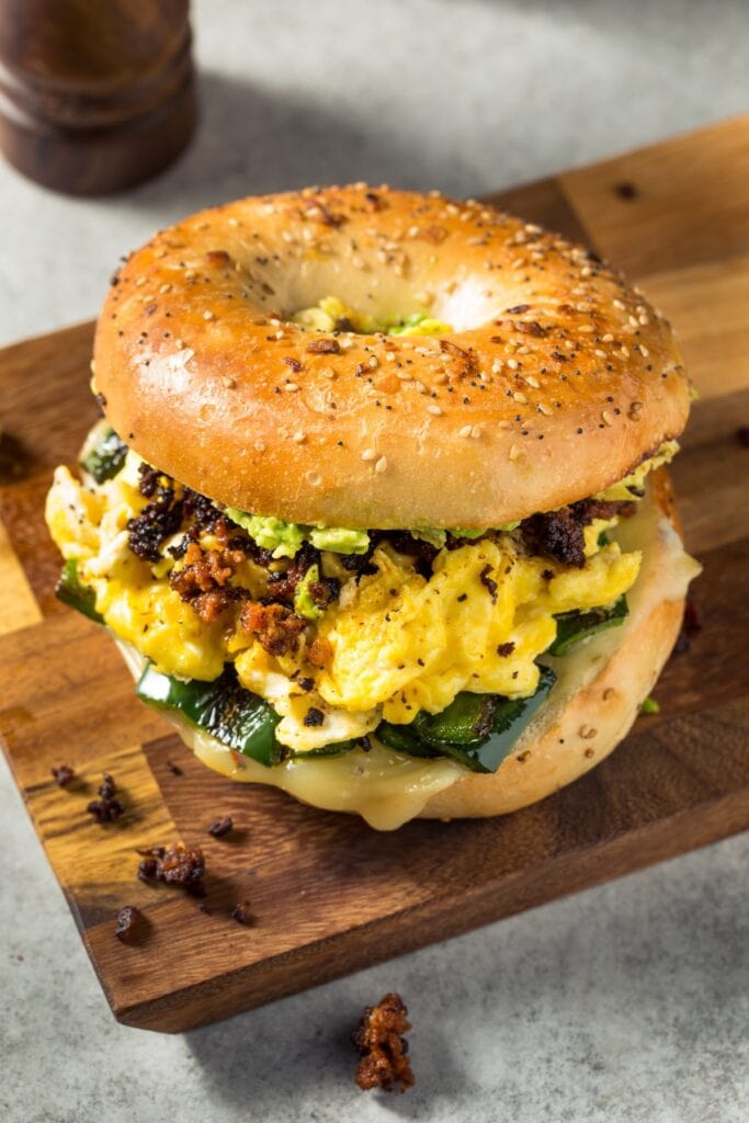 25 Easy Breakfast Meal Prep Ideas featuring Breakfast Chorizo Sandwich on Bagel with Eggs, Cheese, Avocado, and Roasted Peppers