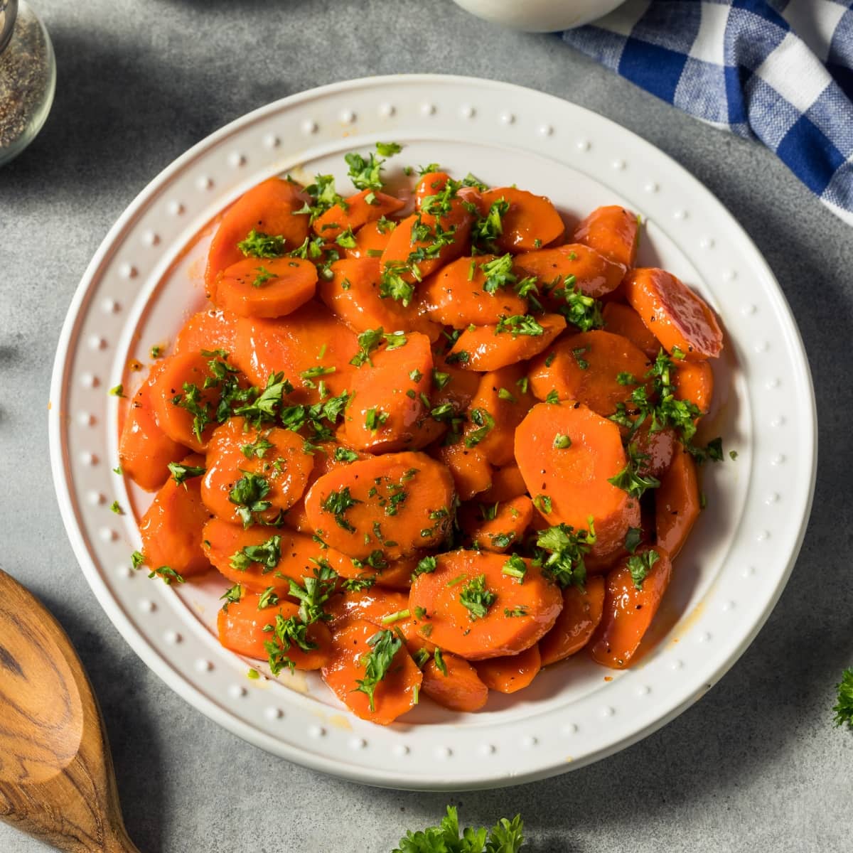 Candied Carrots Served on a Plate Garnished With Parsley
