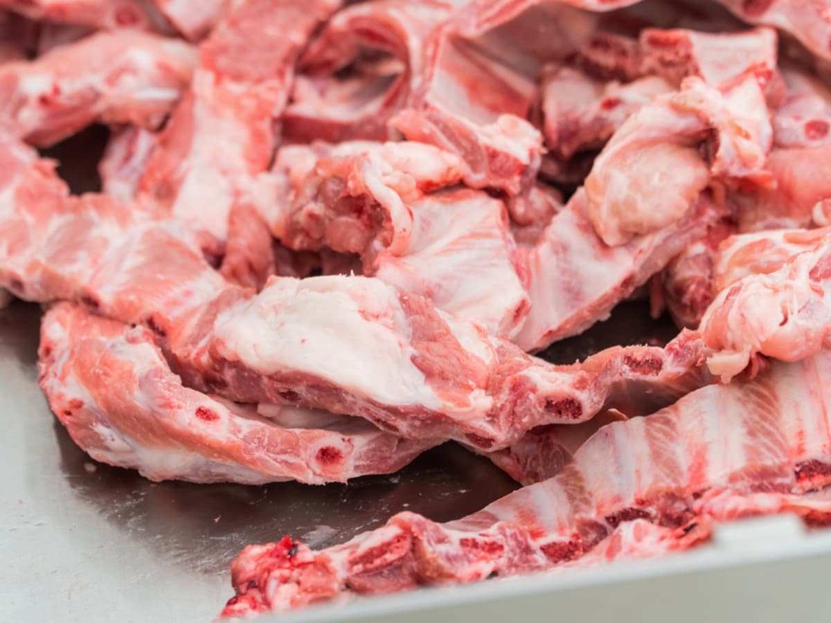Close Up of a Pile of Raw, Marbled, Country-Style Ribs on a Baking Sheet