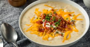 Homemade Crockpot Potato Soup Topped with Cheese, Bacon and Green Onions