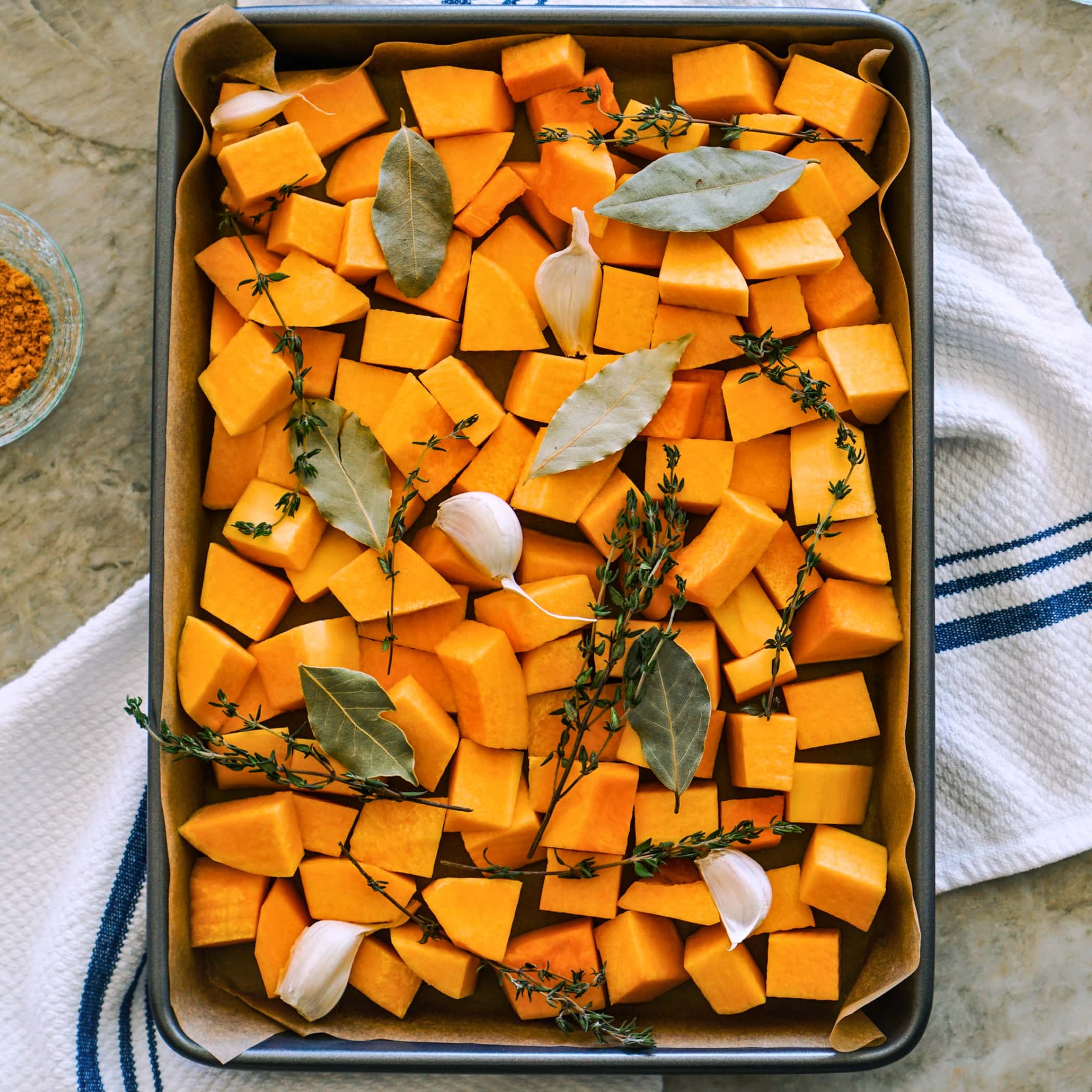 Diced Butternut Squash Laid on a Baking Pan for Roasting