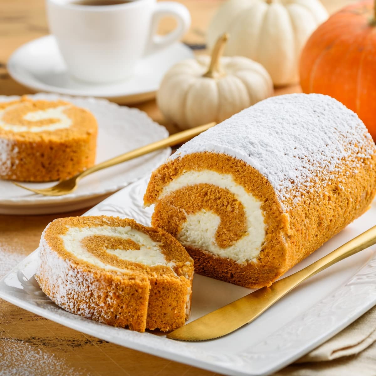 Pumpkin roll on a plate with powdered sugar