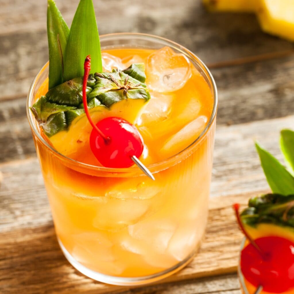 Boozy and Refreshing Mai Tai Cocktail with Pineapple and Cherry Garnish in the Drink