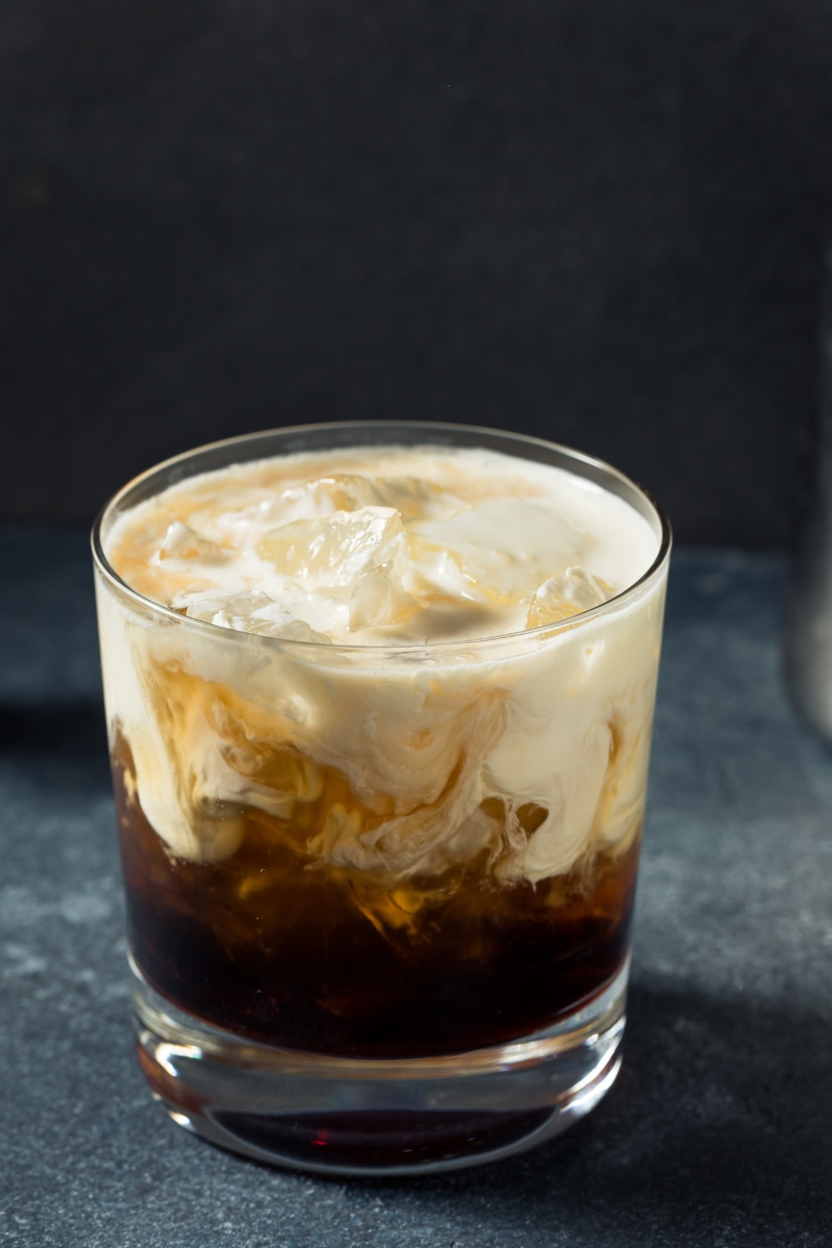 Iced cocktail mixed with cream on a glass.