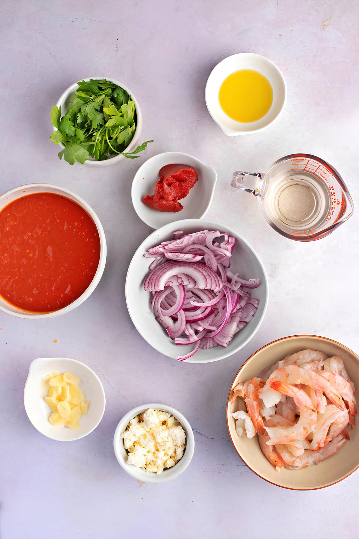 Greek Shrimp Saganaki Ingredients - Olive Oil, Red Onion, Garlic, Tomato Paste, White Wine, Tomato and Olive Pasta Sauce
