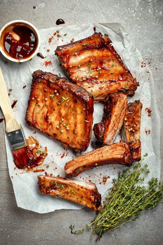 How Long to Cook Ribs in the Oven at 350 featuring Grilled White Ribs on a White Baking Paper