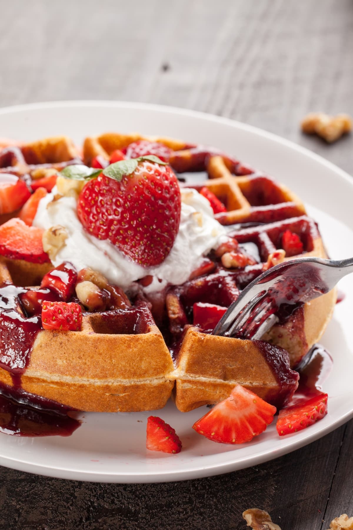 Belgian Waffle Topped With Berries, Nuts and Syrup