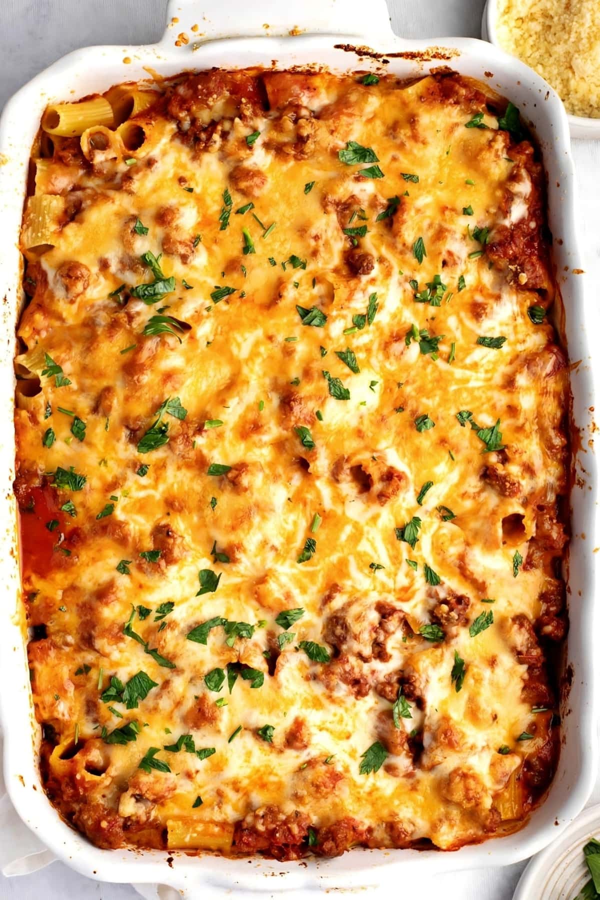 Homemade Cheesy and Meaty Baked Rigatoni on a White Casserole
