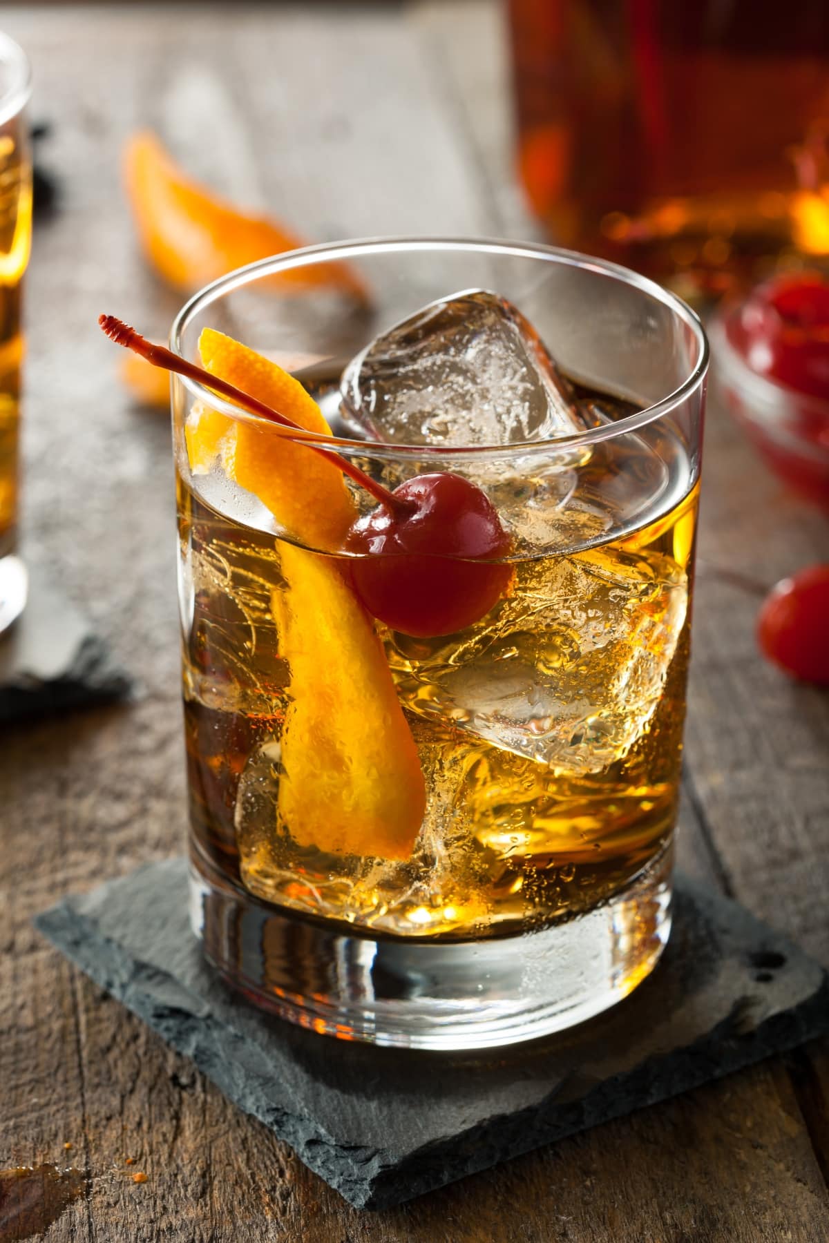 Old Fashioned Cocktail on the Rocks with Maraschino Cherry and Orange Twist