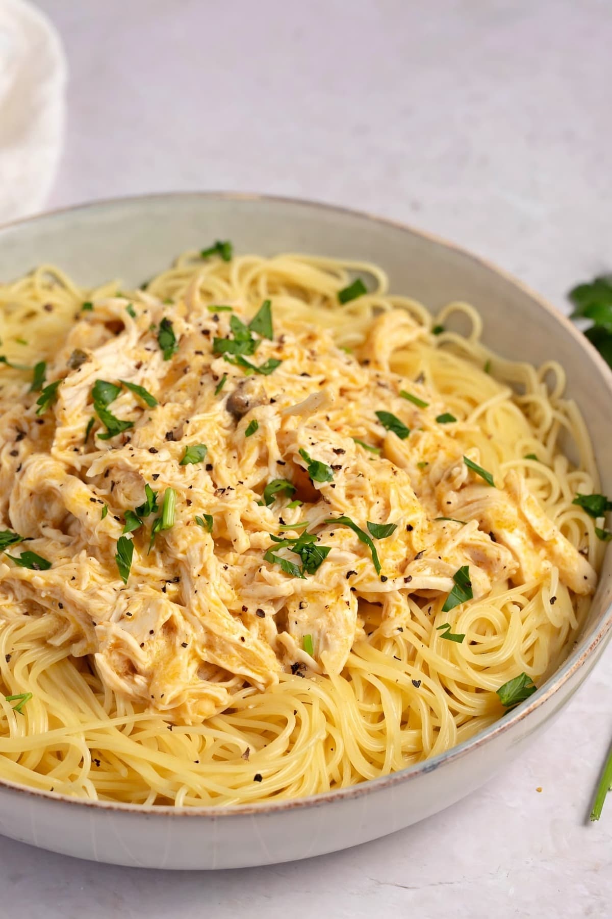 Homemade Crockpot Angel Chicken with Pasta and Herbs in a Bowl