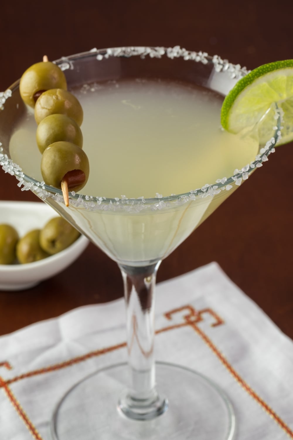 Mexican Martini Cocktail on a Glass Garnished With Olives on Stick