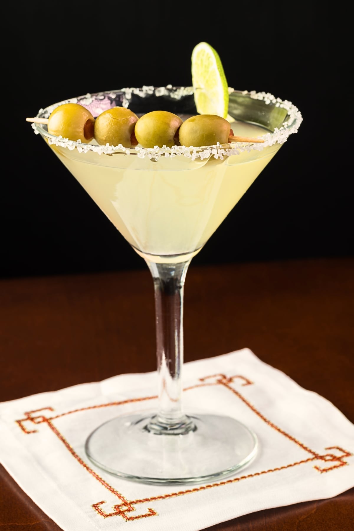 Mexican Martina on a Salted Rim Glass Garnished With Olives
