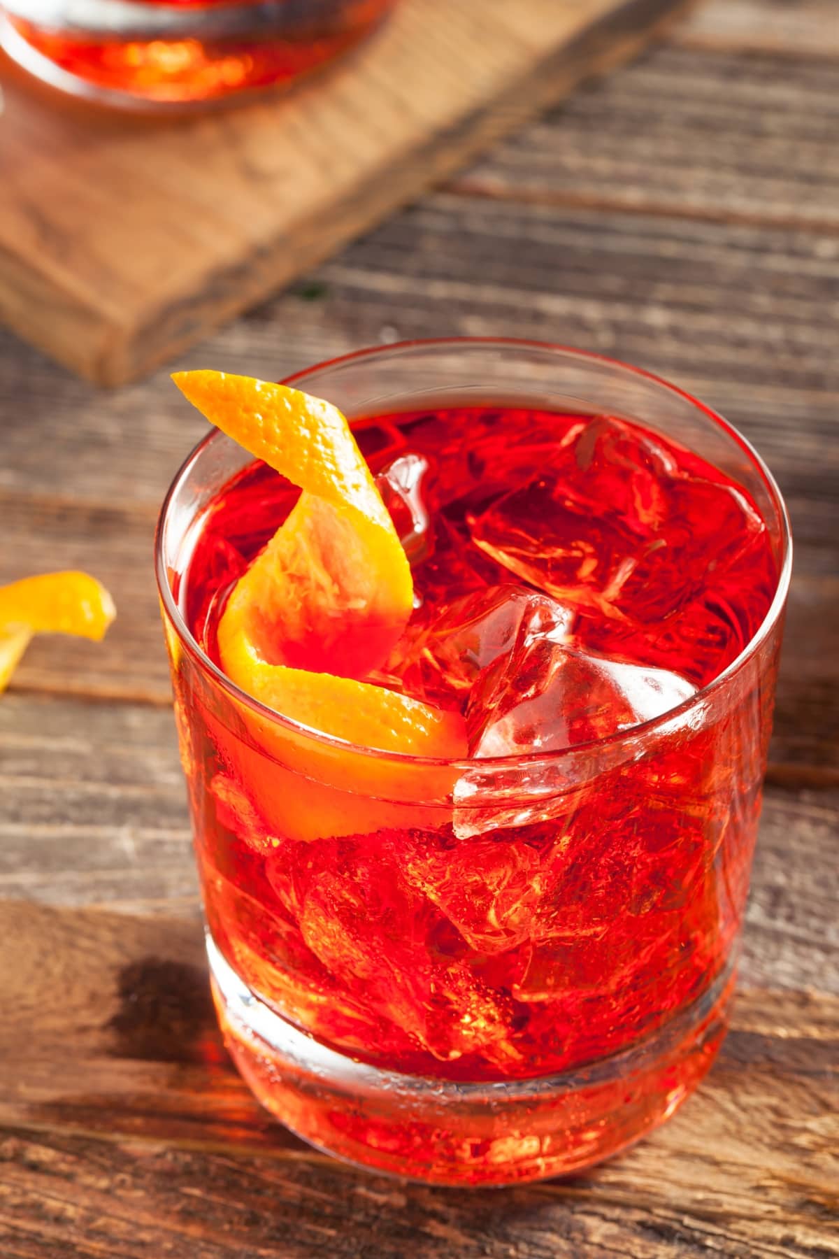 Iced Negroni cocktail with ice and lemon peel.