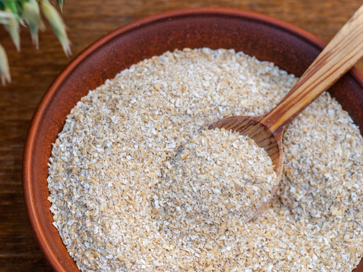 Oat Bran on a Wooden Bowl with Wooden Spoon
