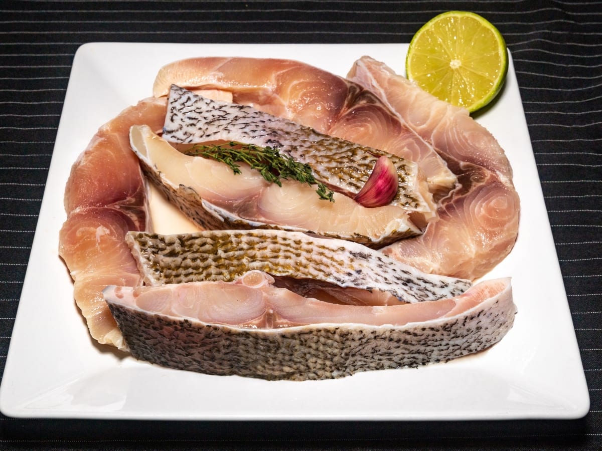 Raw Pacu Fish Ribs on a Serving Plate with a Lime Wheel 