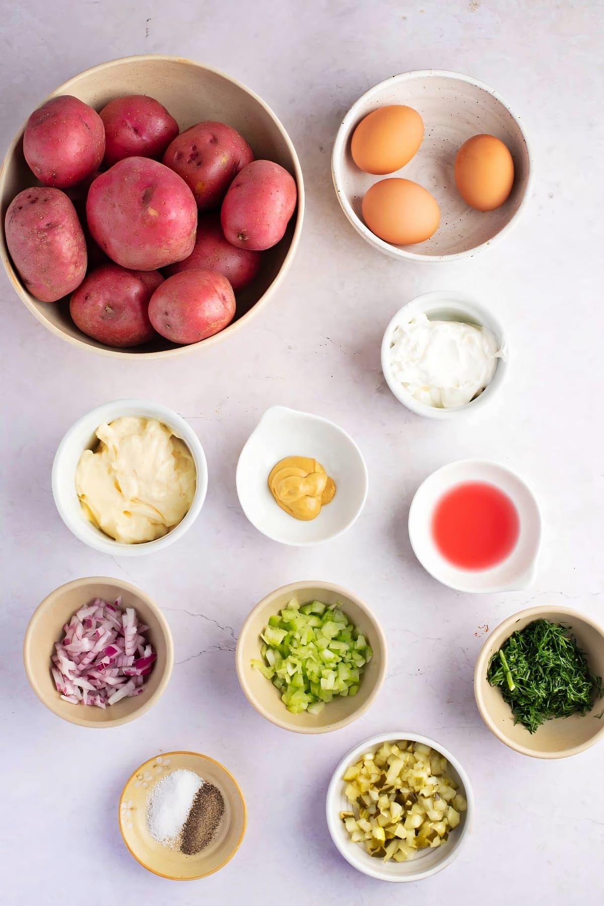 Red Potato Salad Ingredients - Red Potatoes, Mayo, Sour Cream, Dijon Mustard, Red Wine Vinegar, Red Onion, Celery, Seasoning, Dill Pickles and Hard Boiled Egg