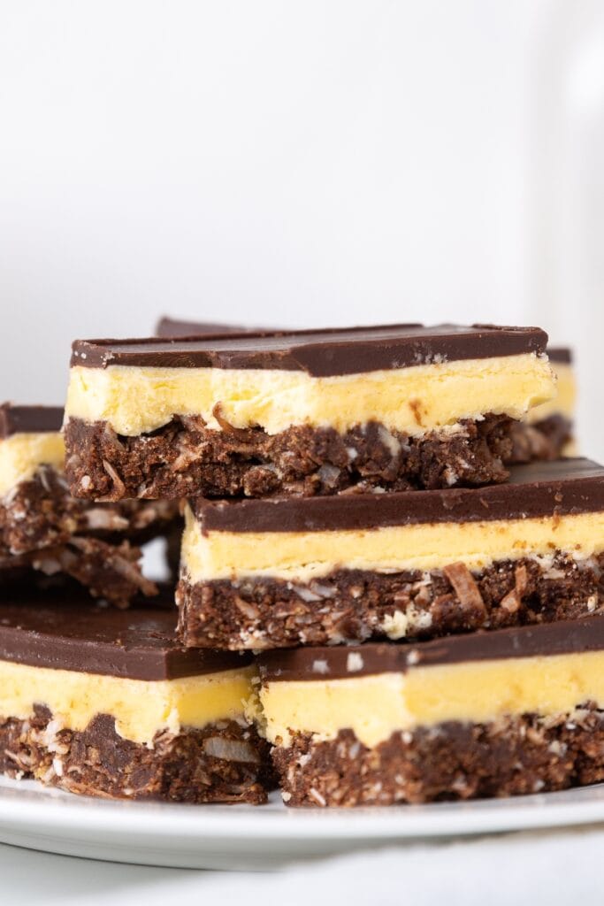 25 Best No-Bake Dessert Bars (Easy Recipes) featuring Stack of Homemade Nanaimo Bars