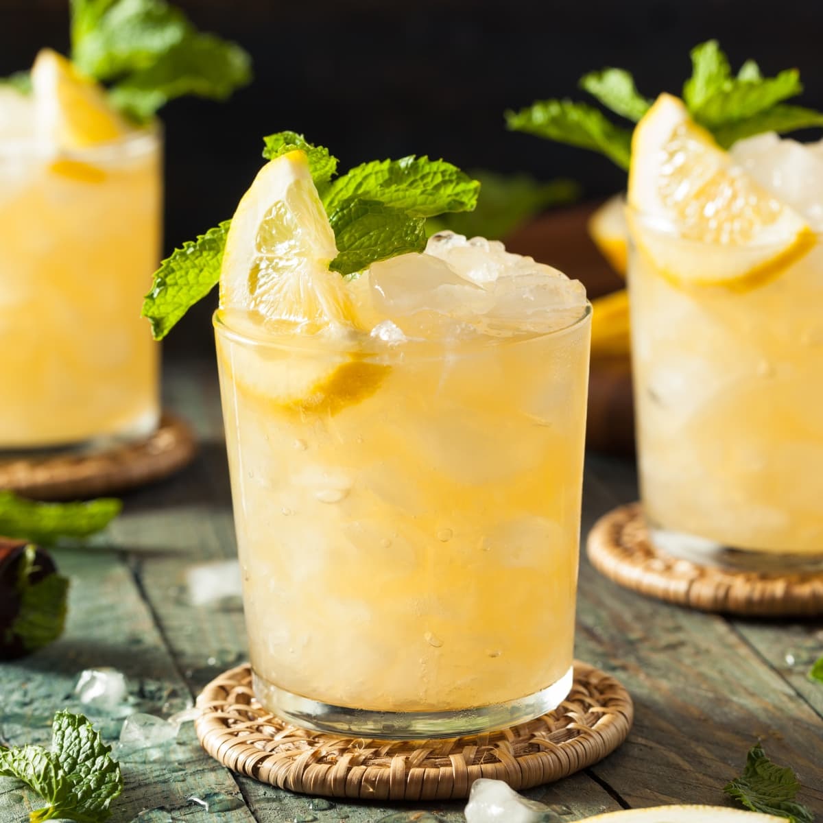 Three Glasses of Iced Bourbon Smash With Lemon and Mint