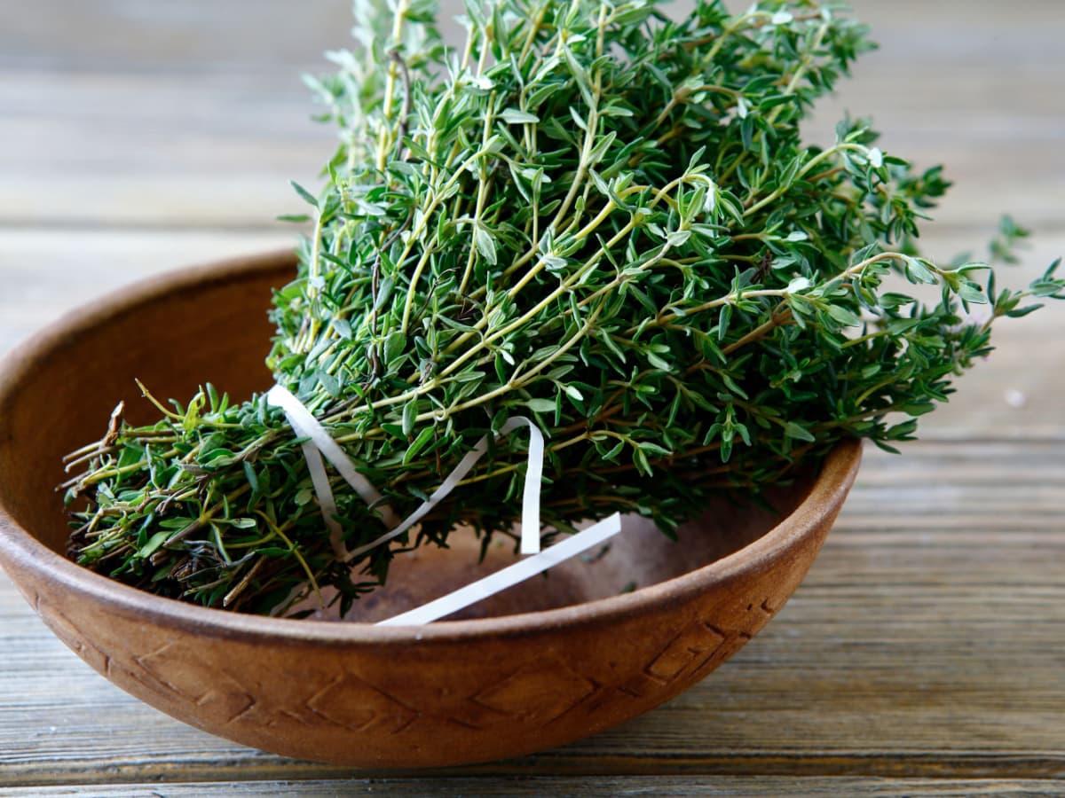 Bunch of Fresh Thyme in a Bowl on a Wooden Table