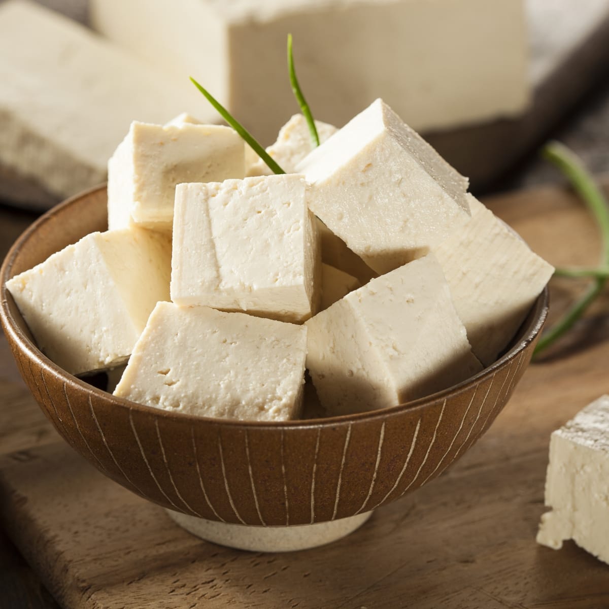 Chunks of Tofu in a Ceramic Bowl on a Wooden Table
