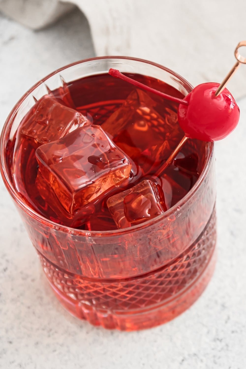 Iced Manhattan Cocktail Garnished With Maraschino cherry