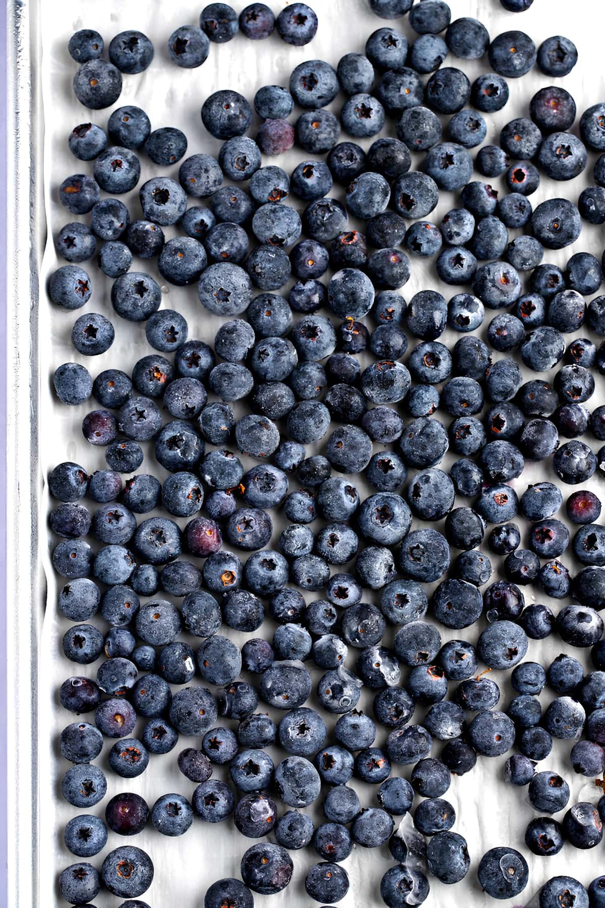 A Bunch of Blueberries Sitting on top of a White Surface
