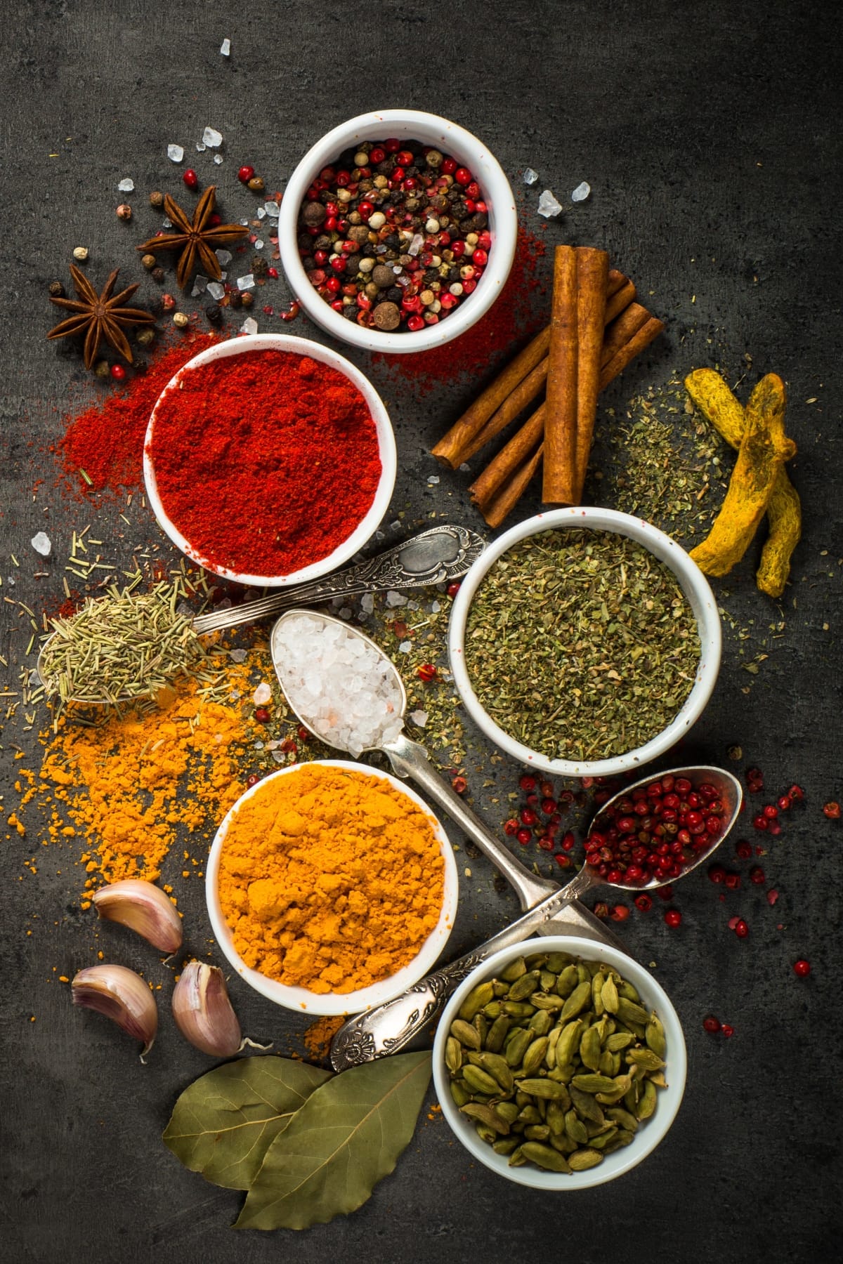 Assorted Spices and Herbs in Bowls and Table Spoons