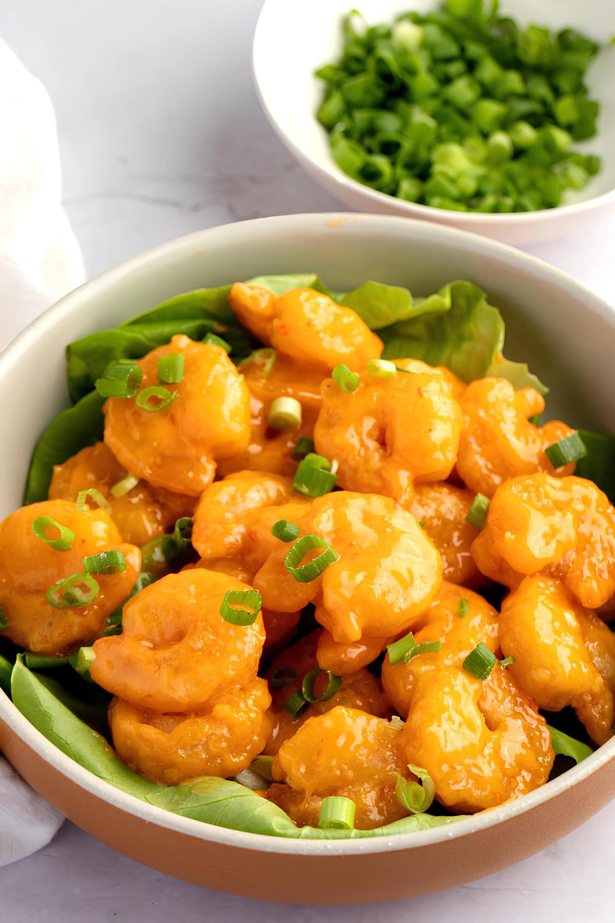 Bang Bang Shrimp with Green Onions and Lettuce in a Bowl