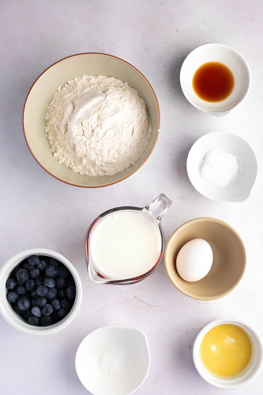 Blueberry Pancakes Ingredients on a White Surface