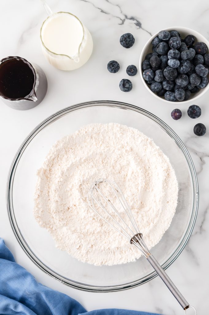 A mixture of all-purpose flour, baking powder, baking soda, white sugar, and salt in a glass bowl.