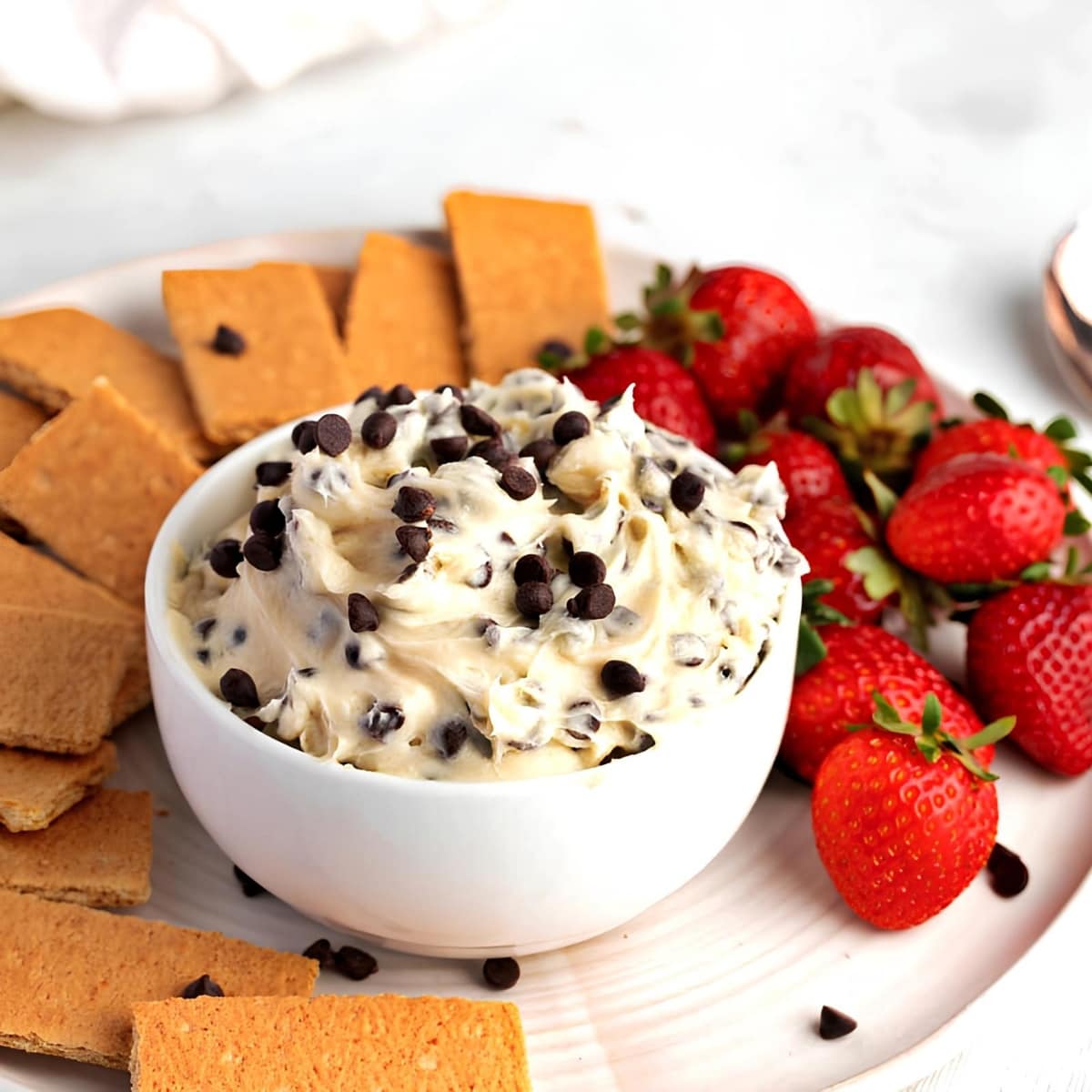 Bowl of Cheesecake Dip and Platter of Crackers and Fresh Strawberries