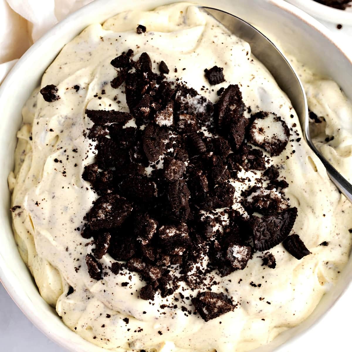 Spoon in Bowl of Oreo Fluff with Crushed Oreo Topping
