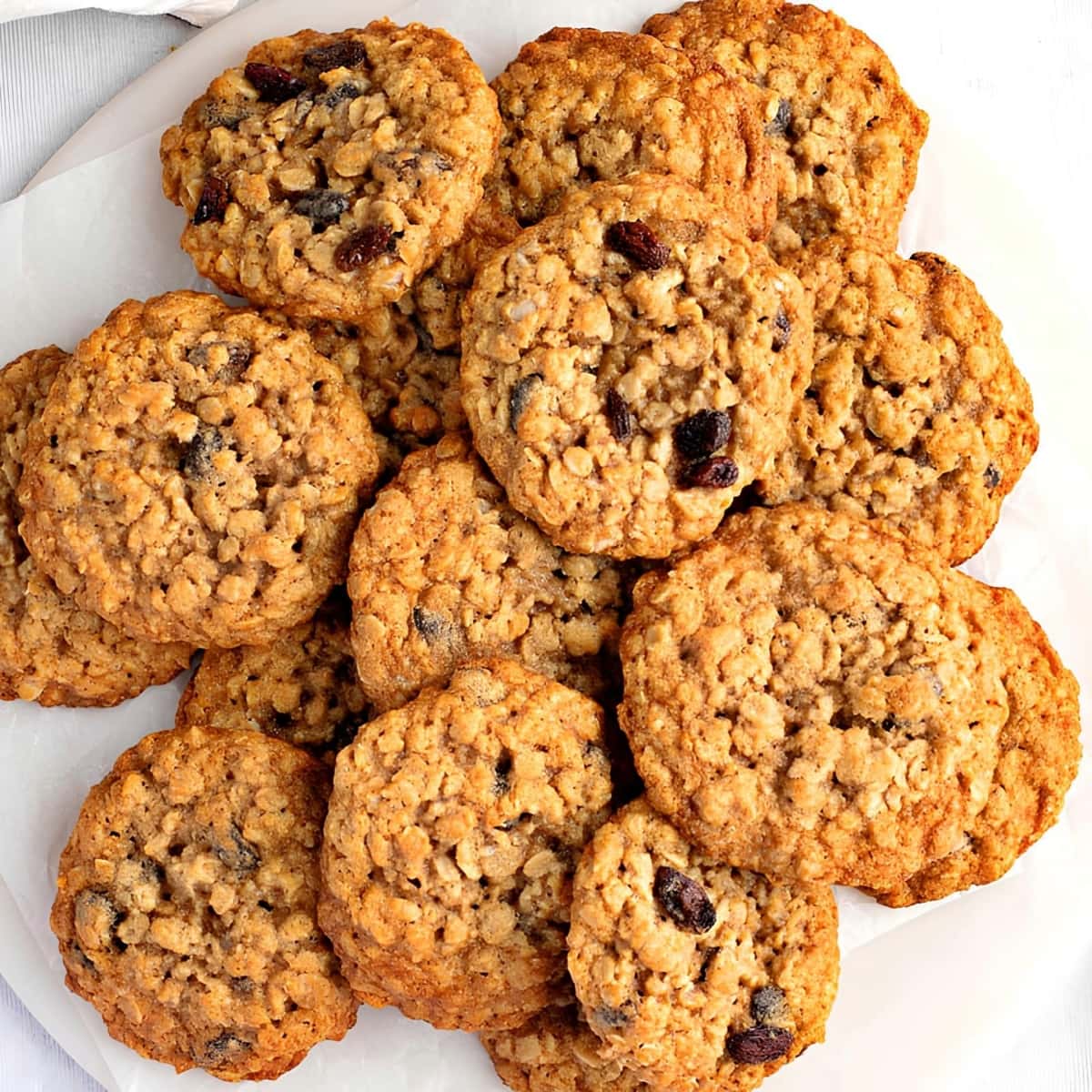 Bunch of Oatmeal Raisin Cookies on a Plate with Parchment Paper