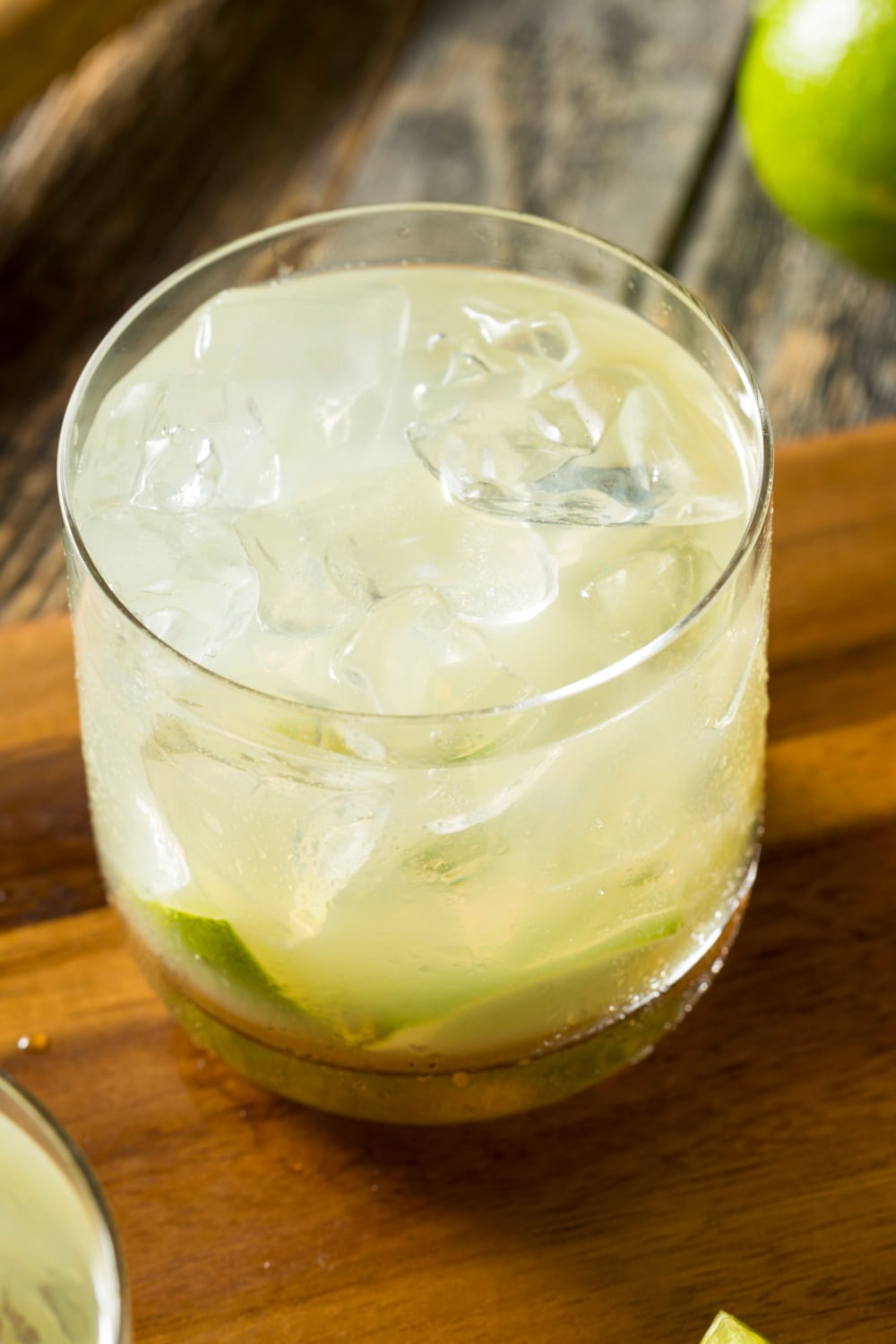 Close up of a glass of Caipirinha Cocktail with lime over ice
