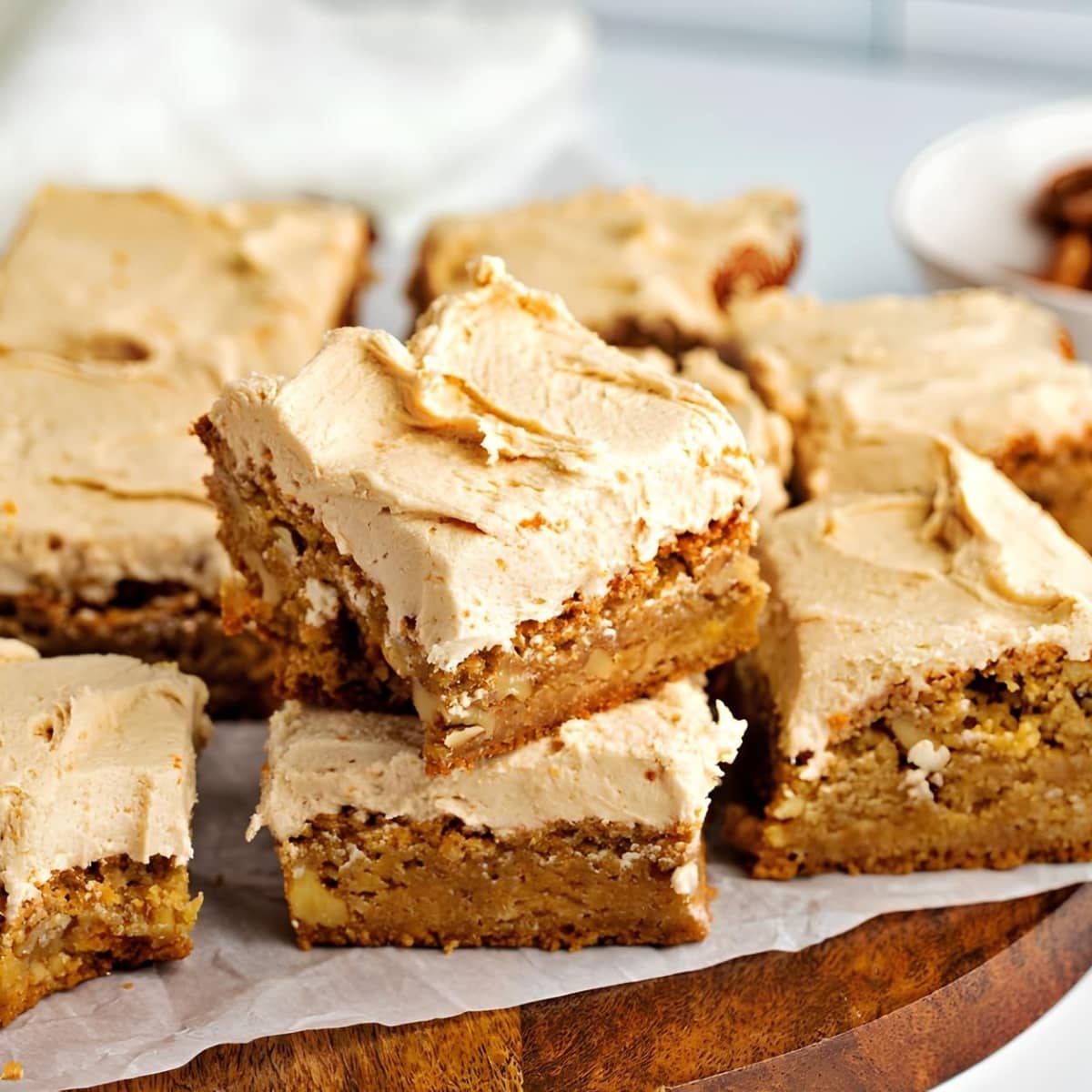 Chewy Butterscotch Brownies with Parchment Paper on a Wooden Board