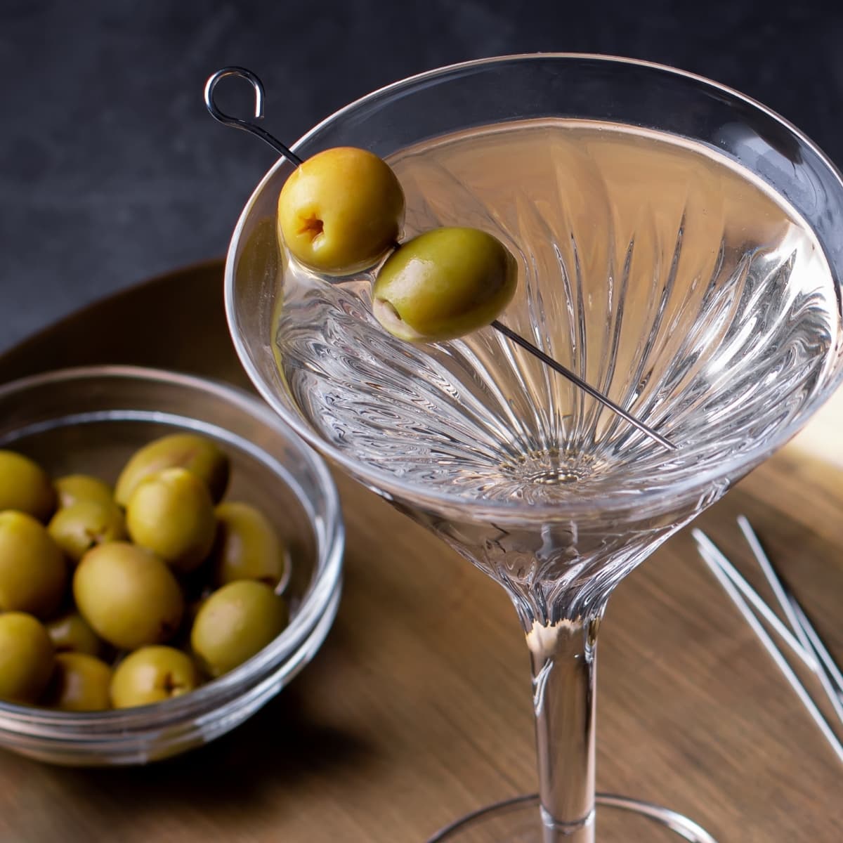Top View of a Glass of Dirty Martini Cocktail Garnished With Olives