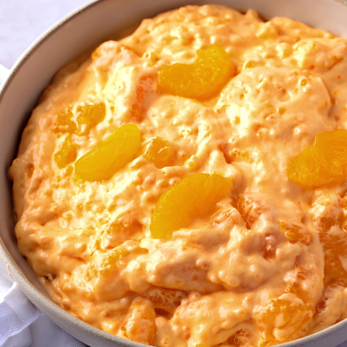 Close up of a Bowl of Orange Creamsicle Salad Fluff with Mandarin Oranges