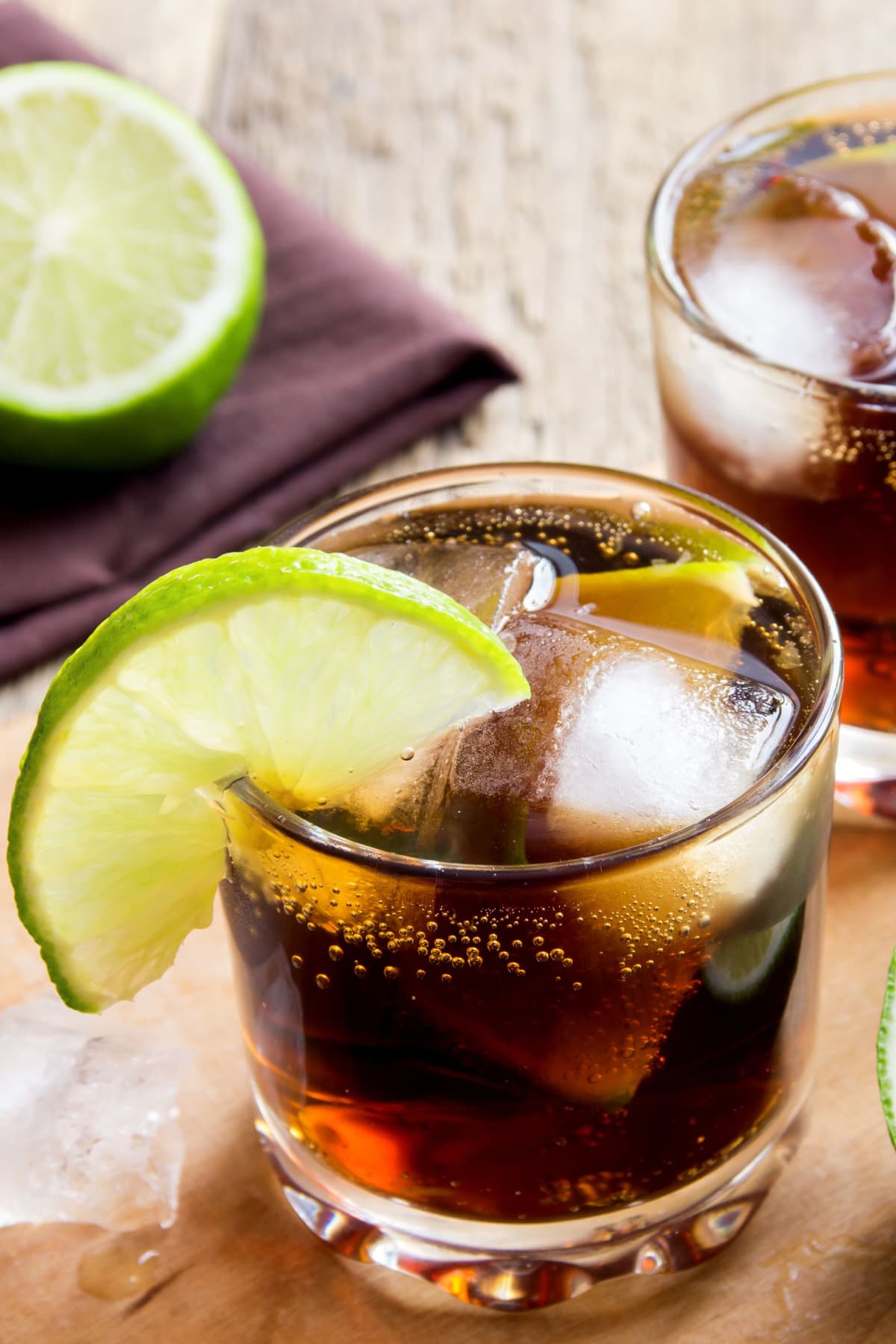Cuba Libre with Lime and Ice on a Wooden Board