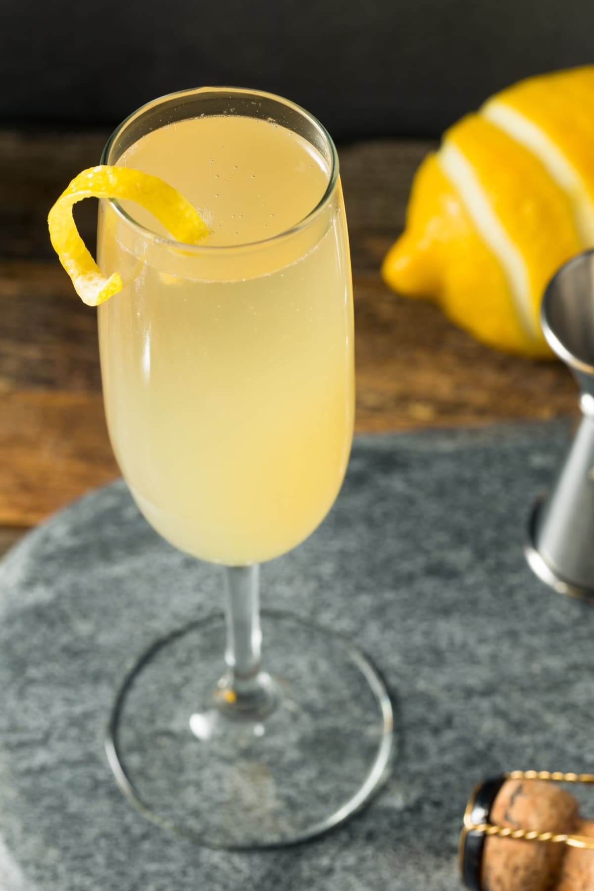 Glass of Boozy French 75 Cocktail with Lemon Peel