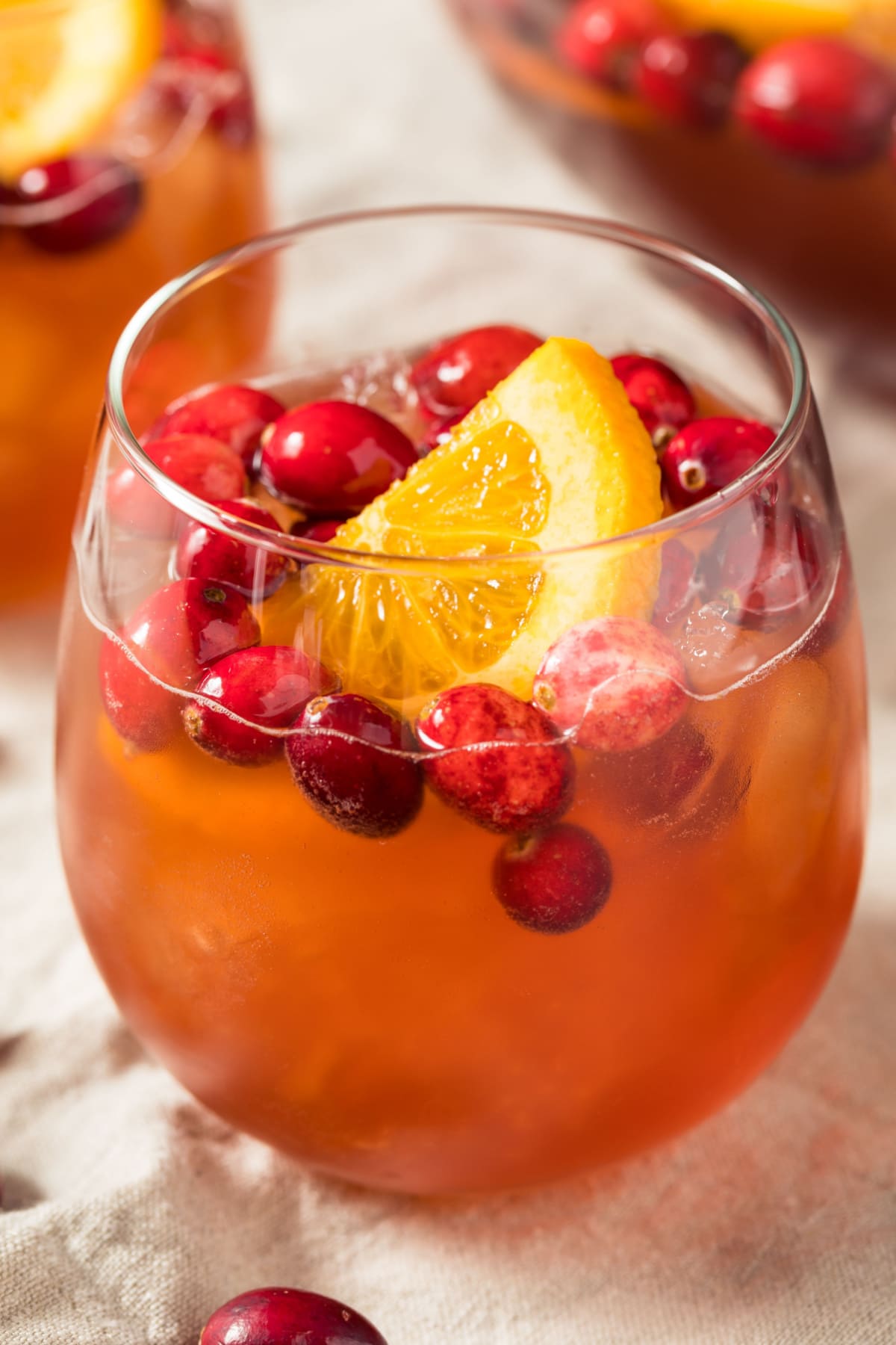 Christmas Punch with Cranberries and a Slice of Orange in a Glass