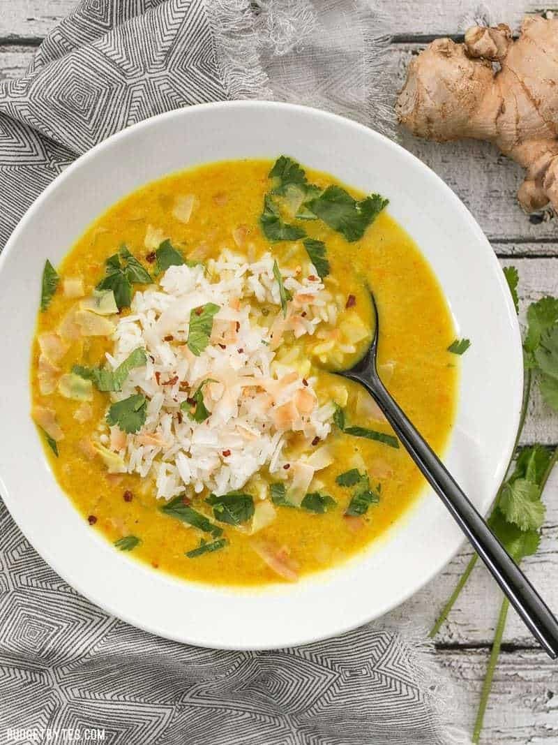 Spoon dipped on a bowl of Golden Coconut Lentil Soup