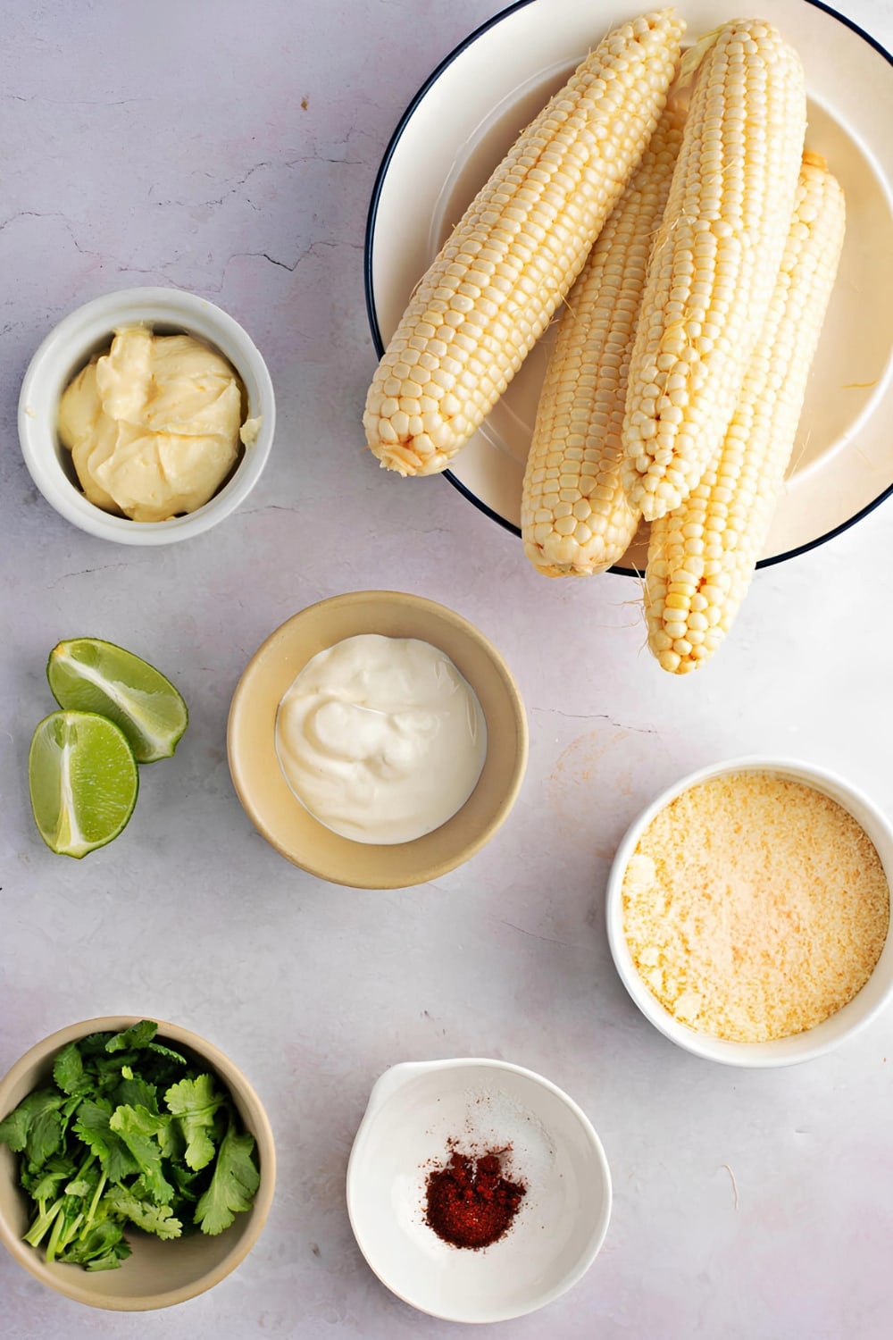 Grilled Mexican Street Corn Ingredients on White Marble Surface