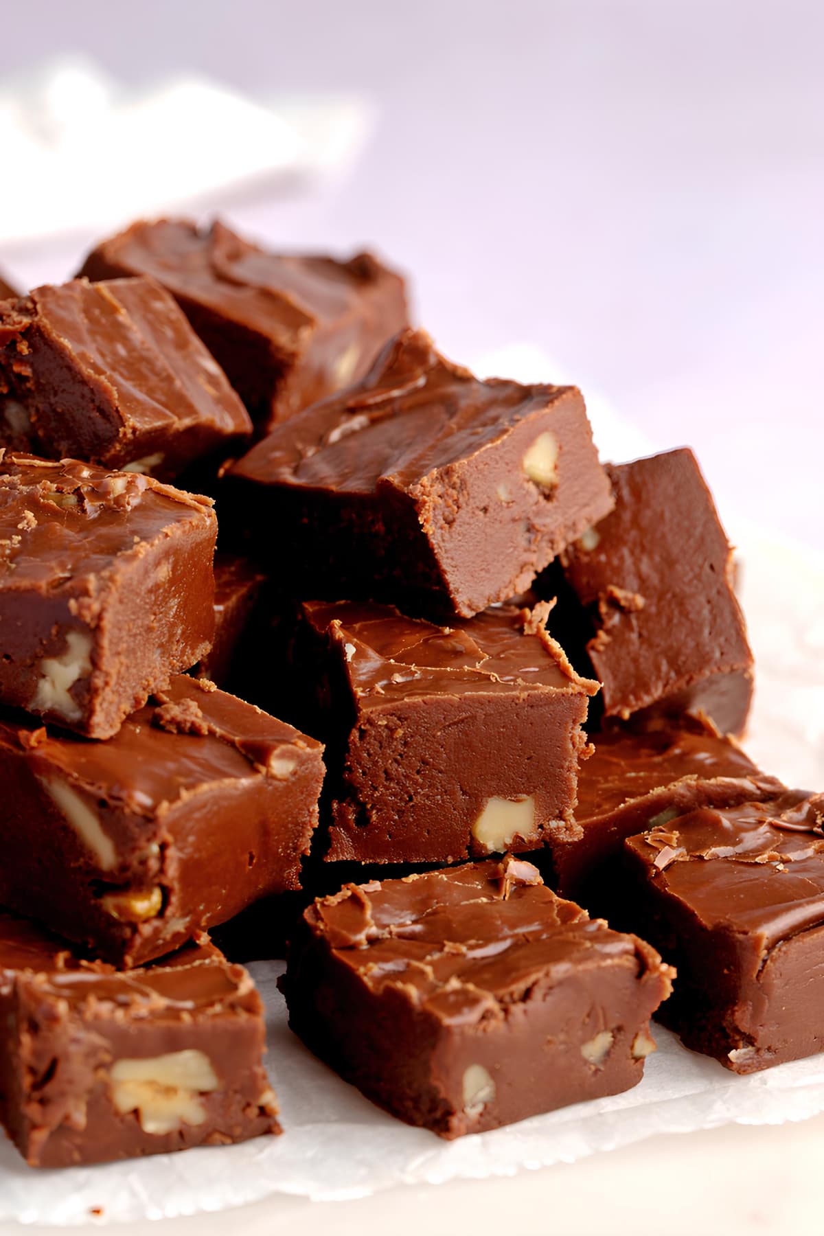 Bunch of chocolate fudge made with  made with chocolate chips, marshmallow creme, and chopped walnuts.