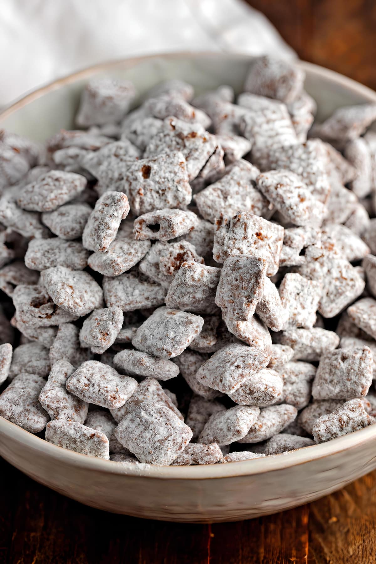 Homemade Puppy Chow with Powdered Sugar in a Bowl
