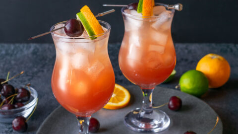 Hurricane Cocktail with Orange, Lime and Cherry