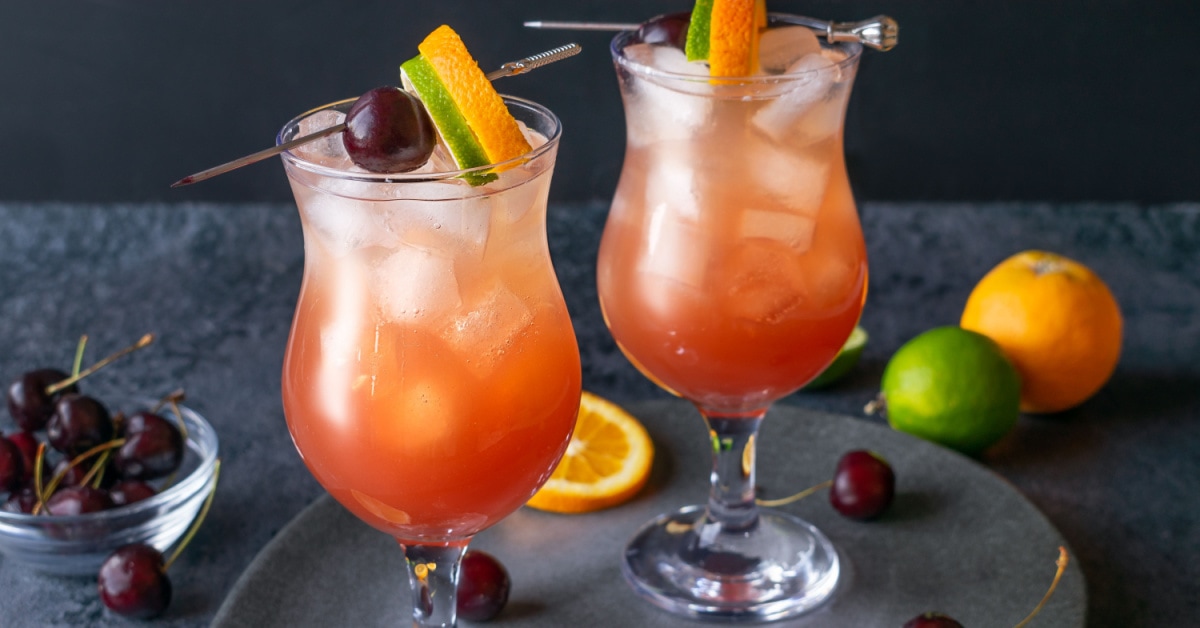 Hurricane Cocktail with Orange, Lime and Cherry