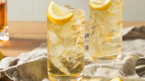 Two glasses of lynchburg lemonade with ice and a lemon wedge, refreshing and perfect for a hot summer day