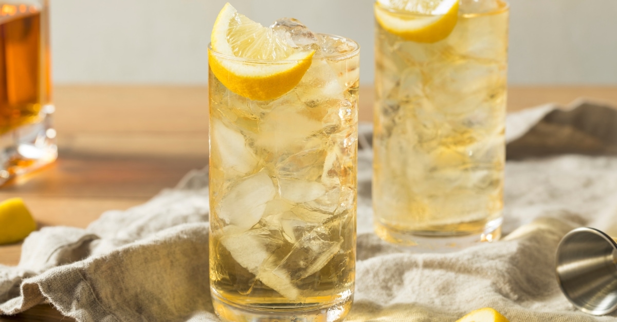 Two glasses of lynchburg lemonade with ice and a lemon wedge, refreshing and perfect for a hot summer day