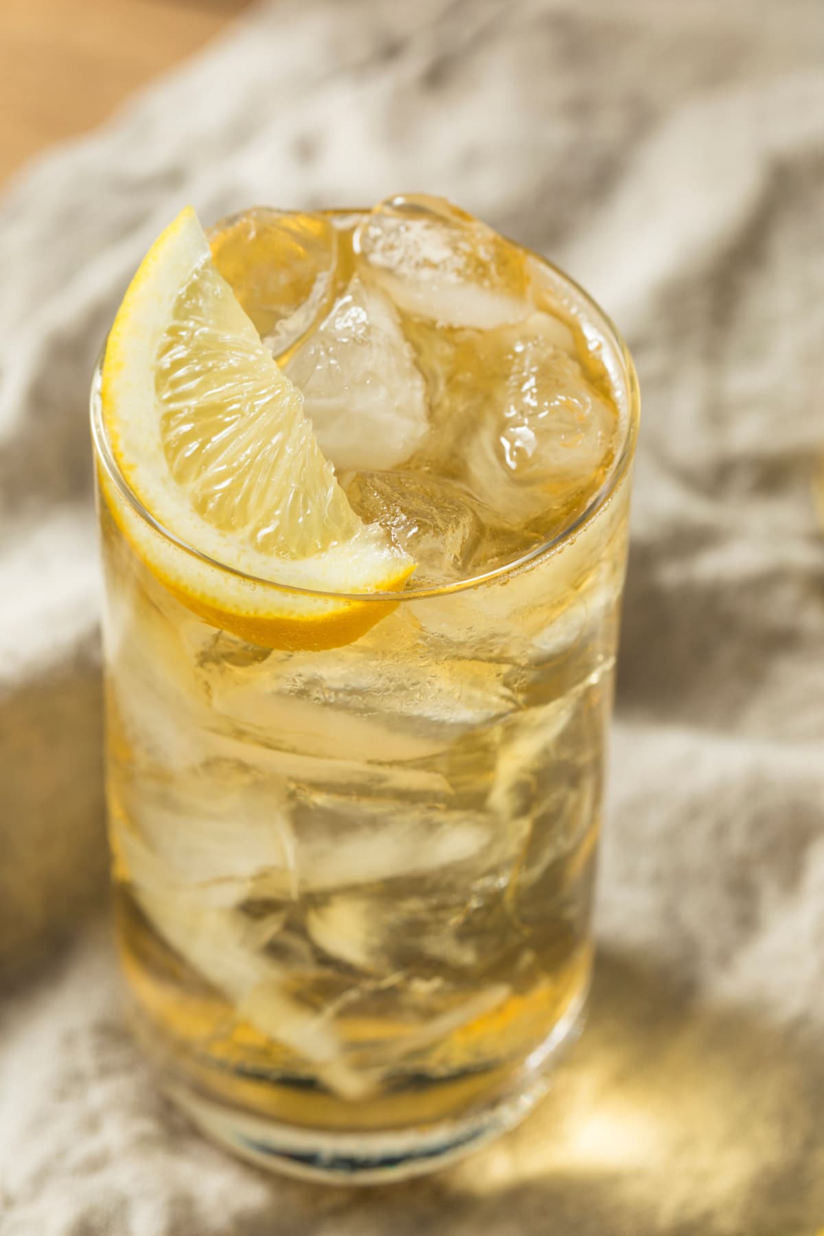Ice filled highball glass of Lynchburg Lemonade with lemon slices. 